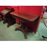 A mahogany card table with gadrooned beading over a spreading square column on quatreform base with