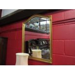 A modern gilt domed top overmantel mirror with bevelled glass,