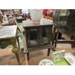 An oak tabletop cabinet with twin doors and shelved interior, beaded edges,