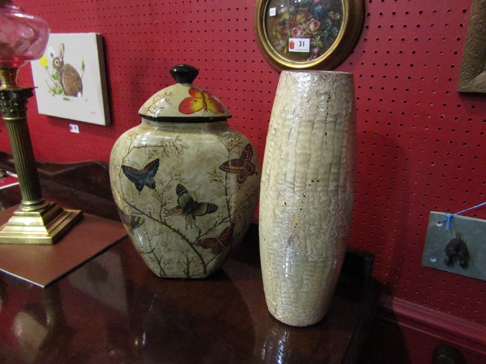 A lidded vase decorated with butterflies and a cylindrical vase, both approx.