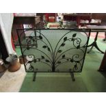 A foliate design mesh fire guard on scroll feet,