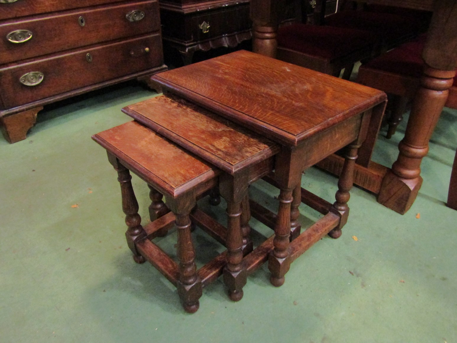 A nest of three oak tables