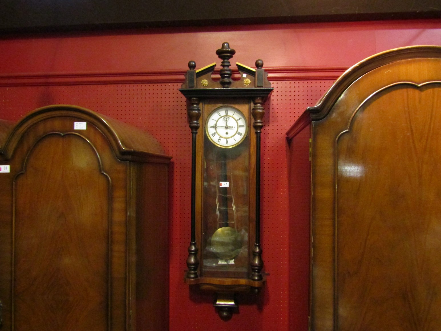 A Vienna wall clock with pendulum and weight,