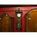 A Vienna wall clock with pendulum and weight,