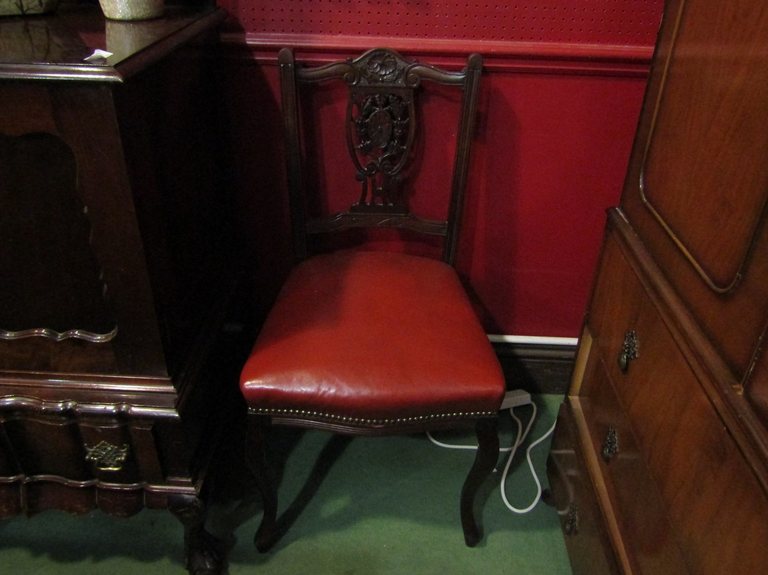 A set of four Victorian dining chairs with pierced splats and leatherette seats