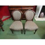 A set of six Victorian carved mahogany dining chairs in blue foliate upholstery on fluted tapering