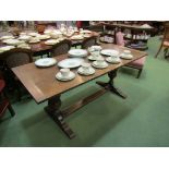 A 20th Century oak trestle table with bulbous supports to stretcher base,