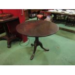 A George III mahogany revolving circular tilt top wine table on a cannon barrel column and tripod