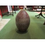 A large red embossed vase,