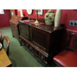 An early to mid 20th Century Dutch style sideboard with two doors over two drawers,