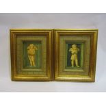 A pair of Raphael's cherubs oleographs in gilt frames,