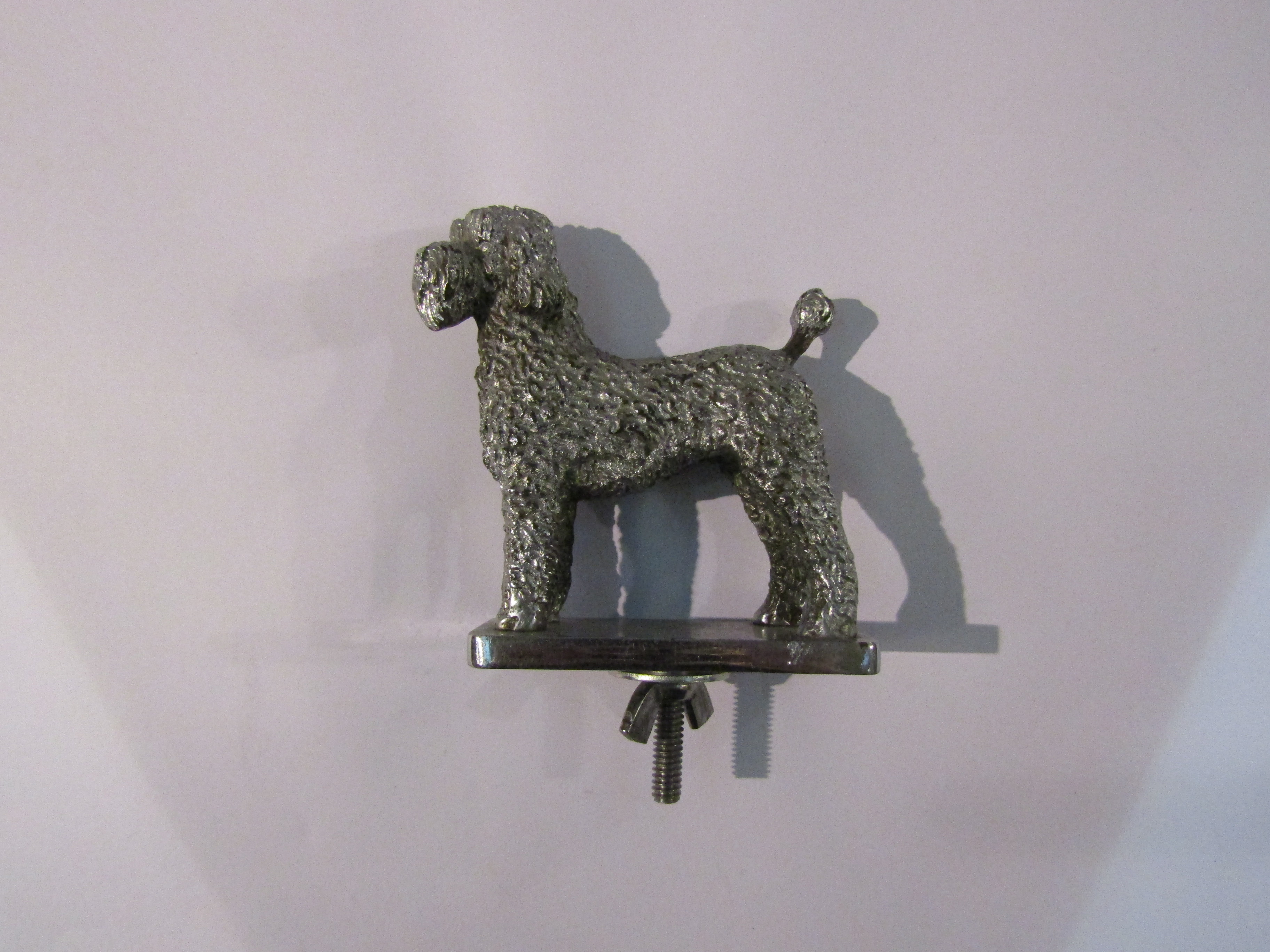 A vintage poodle car mascot