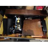 A vintage Singer electric sewing machine in case