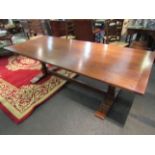 An 18th Century style oak refectory dining table on turned legs and sledge feet joined by a