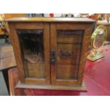 A late 19th Century oak smoker's cabinet