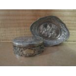 A silver trinket box of oval form,