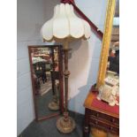 A gilded standard lamp with shade