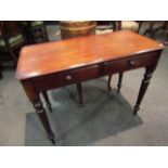 Circa 1860 a mahogany side table the two frieze drawers over turned and tapering legs 91cm x 44cm x