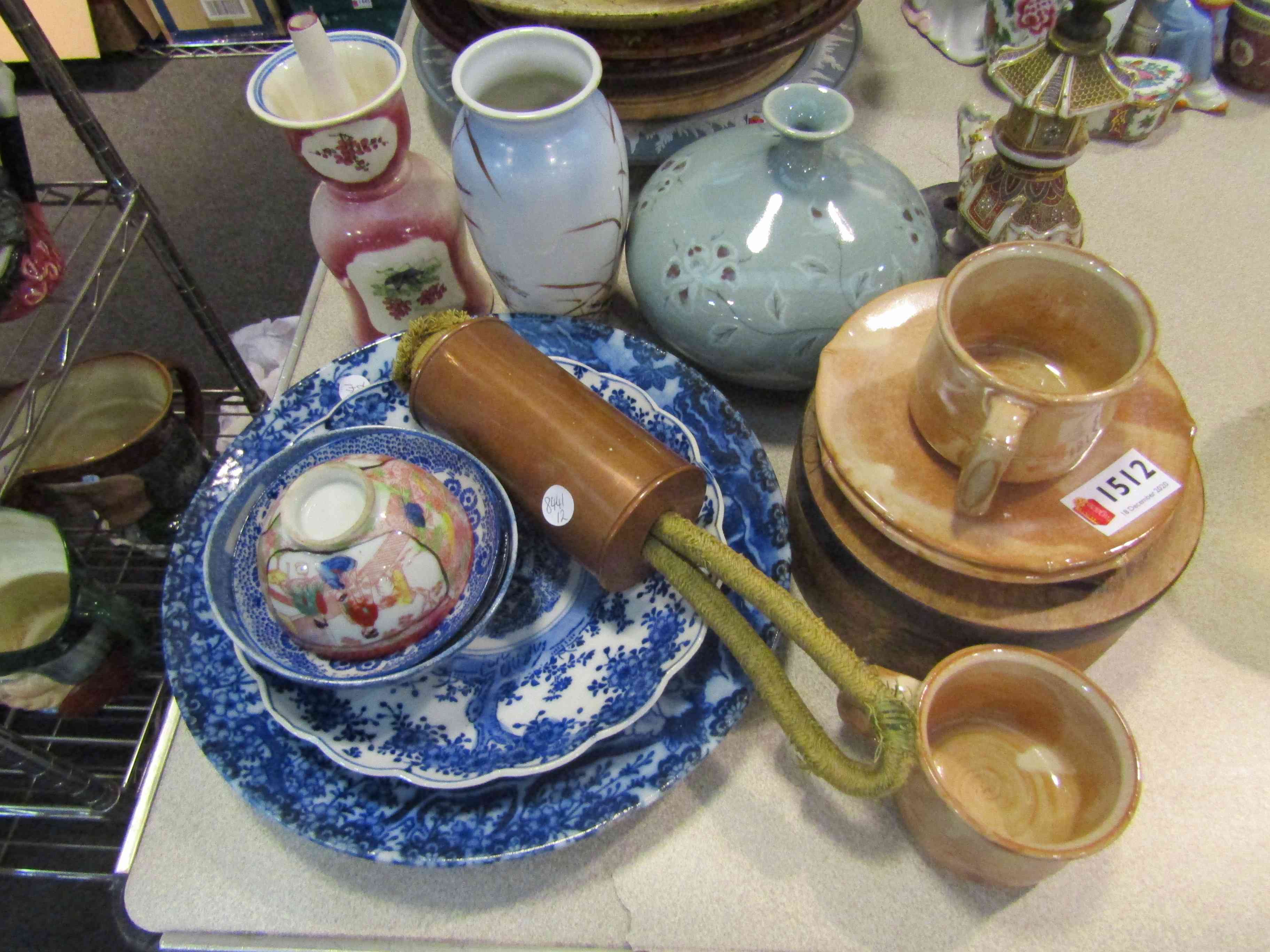 A Japanese Mon engraved copper scroll weight and various Japanese ceramics