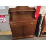 A Regency style mahogany chiffonier with raised shelf back and holly inlaid decoration the single