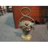 A brass foliate flatback doorstop