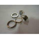 Four 9ct gold rings and another,