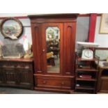 A Victorian walnut single wardrobe, the mirror door with key over a single base drawer,