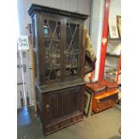 A heavily carved oak bookcase with astragal glazed doors,