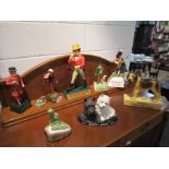 A collection of pub brewery and cigarette advertising figures including Dewars, Johnnie Walker,