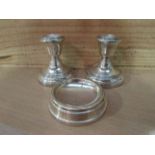 A pair of silver squat form candlesticks and an ashtray (3)