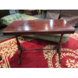 A Victorian mahogany stretcher table with brass castors