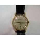 A 1960's Garrard gentleman's gold wristwatch, silvered dial with sweep second dial, teardrop lugs,