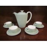 A Poole pottery mint coloured part coffee set comprising of coffee pot and four cups and saucers