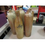 Five stoneware salt glazed liquer bottles