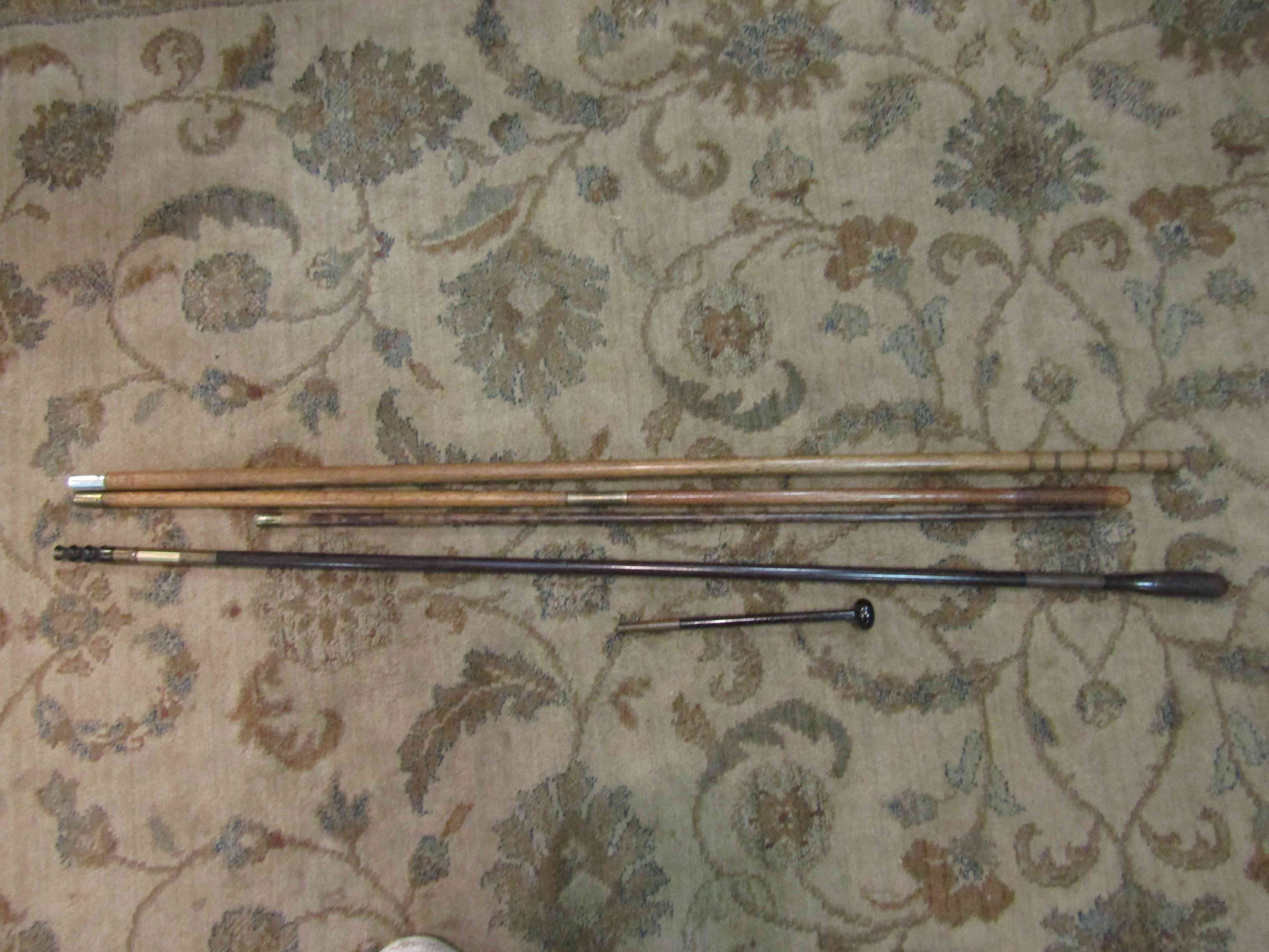 Three vintge cleaning rods and a pistol cleaning rod