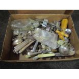 A box of plated flatware