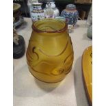 A circa 1960 amber frosted glass vase, three raised fish design,