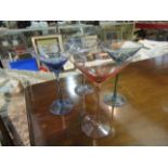 A set of four coloured glass Martini glasses