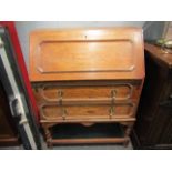 An early 20th Century oak bureau, fall front over two drawers,