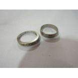 An 18ct white gold textured wedding band and a white metal dress ring stamped 9k