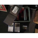 A box containing albums and postcards