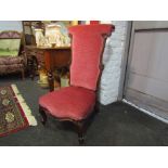A Circa 1840 walnut open armchair with carved decoration on scroll foot cabriole legs and brass