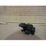 A limited edition solid bronze frog,