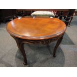 A French style parquetry circular top occasional table on carved cabriole legs,