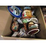 A box containing assorted Great Yarmouth pottery mugs and plates