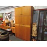 A mid Century Uniflex teak wardrobe, two pairs of doors,