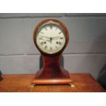 An early 20th Century mahogany balloon clock with Roman numerals,