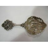 A Victorian silver pierced spoon with Romanesque design and foliate relief