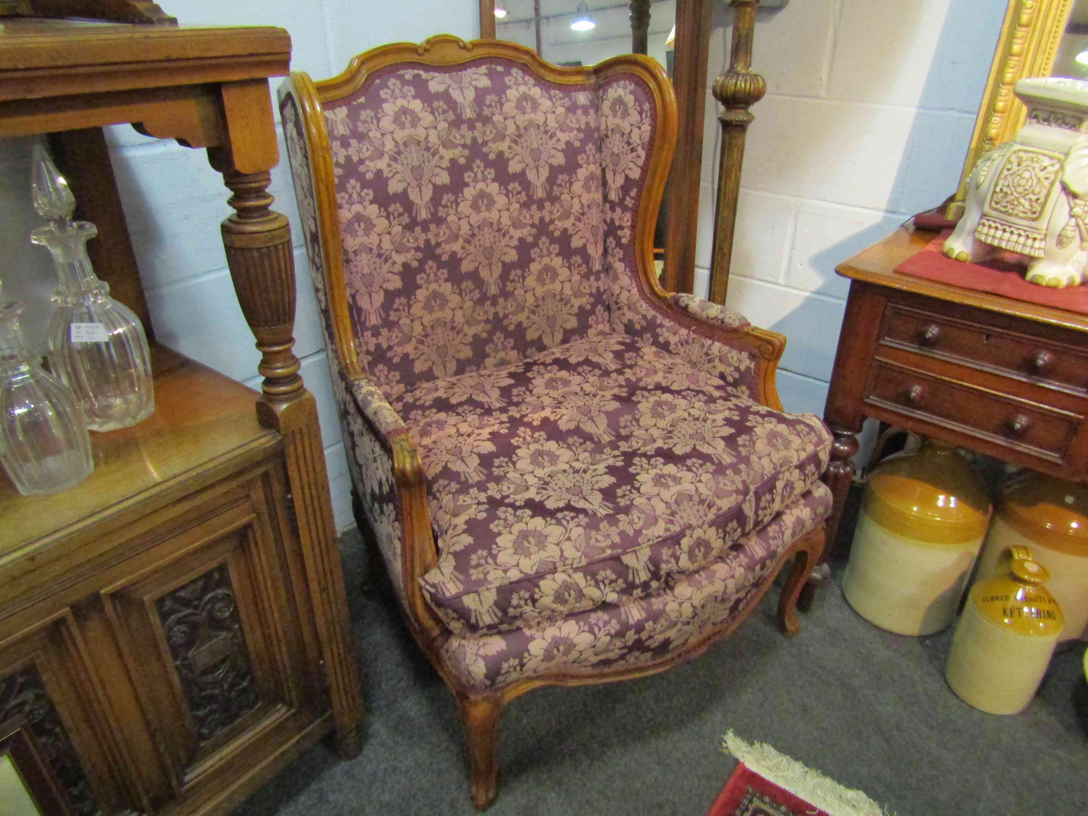 A pair of 1920's/30's French floral upholstered armchairs on cabriole legs