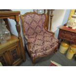 A pair of 1920's/30's French floral upholstered armchairs on cabriole legs